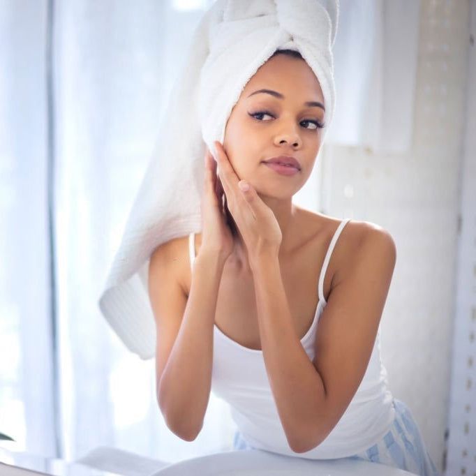 woman looking at her self in mirror spa like